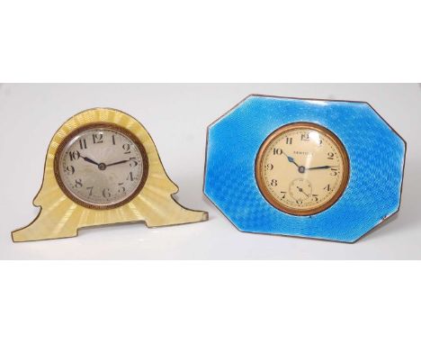 An Art Deco silver and yellow guilloche enamel decorated helmet shaped strut bedside clock, having winding movement, dial dia