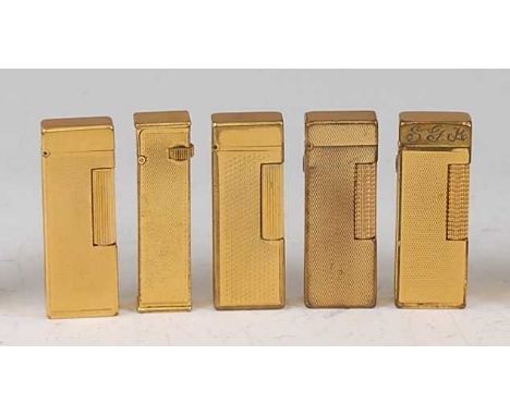 A collection of five various Dunhill gilt metal pocket cigarette lighters, each with engine turned decoration and typical hin
