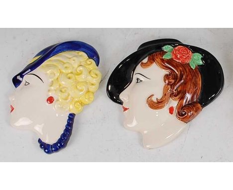 Two Moorland glazed ceramic wall masks, each underglazed painted and stylised female profile bust portraits, each with printe