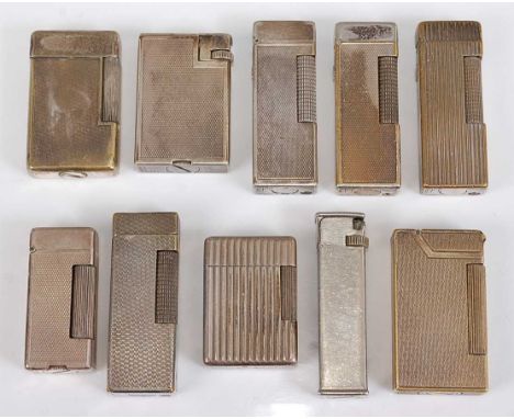 A collection of nine Dunhill silver plated pocket cigarette lighters, six having engine turned decoration, two with ribbed ve