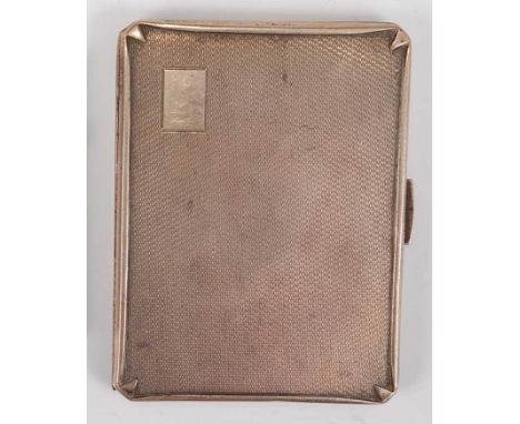 An Art Deco silver engine turned hinged pocket cigarette case, having slightly raised border with pinched faceted corners, gi
