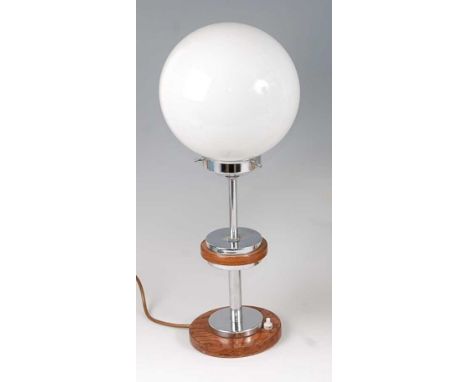 An Art Deco walnut and chrome table lamp, having a milk glass globular shade over circular central platform to conforming bas