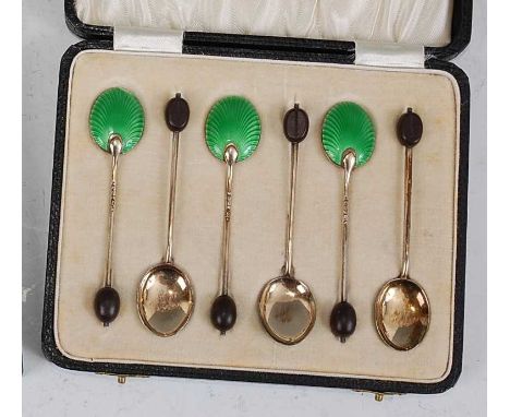 A set of six Art Deco silver and green guilloche enamel decorated coffee bean spoons, each with ebonised coffee bean terminal