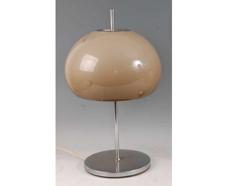 In the manner of Harvey Guzzini - a chrome table lamp, having a plastic domed shade, the rod column raised on circular base, 