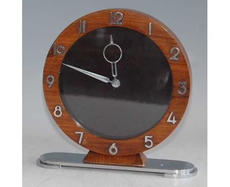 An Art Deco walnut and chrome mantel clock, the plain circular dial with outer stylised bezel numerals, angular shaped hands,