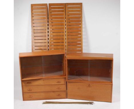 A 1970s teak Ladderax modular wall unit, comprising one three drawer chest compartment, one fallfront cupboard compartment, t