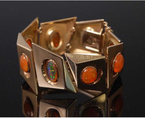 A 1970s 14ct gold and fire-opal set bracelet, comprised of eight angular panels each with various shaped cabochon cut stones,