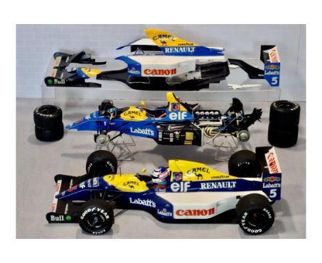 Two Tamiya models measuring approximately 400 mm in length, one exposing the internal workings, meticulously constructed with