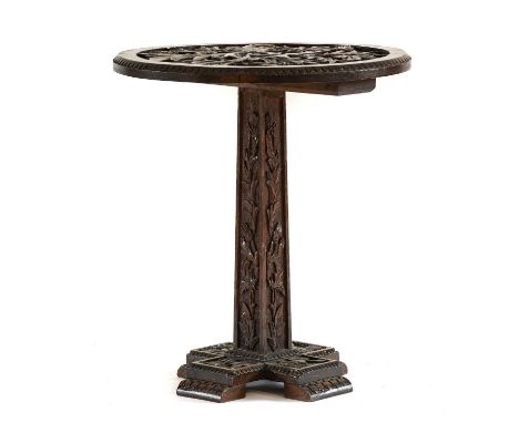 A Scottish Carved Oak Occasional Table, circa 1900, the circular top with stiff leaf carved border and trailing leaves, on a 