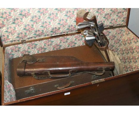 A Large Stained Pine Trunk, 126cm by 64cm by 78cm, containing a vintage set of golf clubs, a leather leg of mutton gun case, 