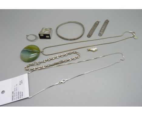 A silver necklace, a ring, a pendant, a bangle, a bracelet, etc. 