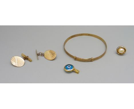 A 9ct gold bangle, 3g, 47mm, a pair of 9ct gold cufflinks, 2.3g, a 14ct gold charm and a single earring 