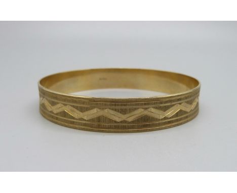 A yellow metal bangle marked 333, 15.6g, 65mm 
