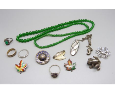 A silver frog brooch, a silver and mother of pearl pendant, a silver and enamel maple leaf brooch and other jewellery 