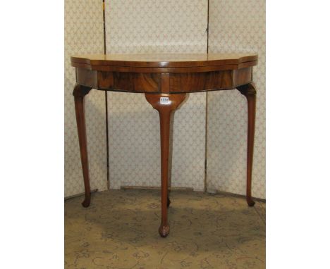 A Queen Ann style walnut figured and burr walnut veneered demi-lune fold over top card table with serpentine outline and rais