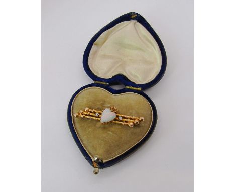 Yellow metal sweetheart brooch set with a heart shaped opal flanked by a pair of diamonds, 4.5cm L approx, 3.7g, contained in