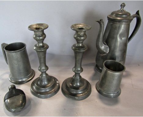 Pewter ware consisting of a coffee pot, two tankards, a pair of candlesticks and a hip flask. 6 