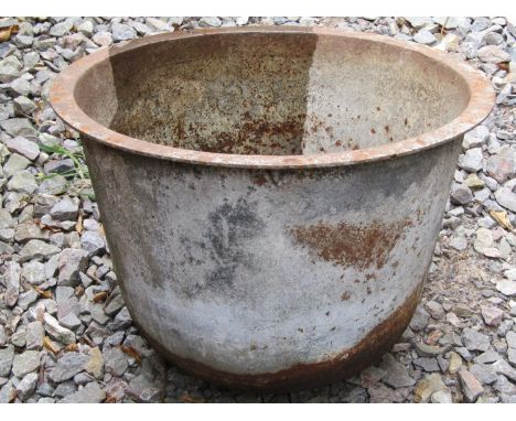 A vintage cast iron cauldron/tub of circular tapered form with flared rim and rounded bottom, 54 cm diameter together with a 