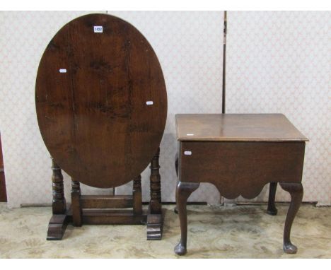 A good quality reproduction Old English style oak oval folding occasional table with gateleg action, raised on turned bobbin 