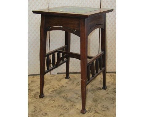 An arts and crafts oak occasional table the over hanging square top enclosing a decorative glazed ceramic panel, over a piece