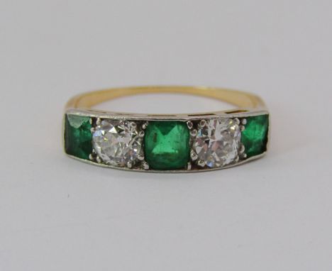 Five stone emerald and diamond ring, one white stone tests as a diamond, the other tests as a moissanite, the diamond 0.25cts