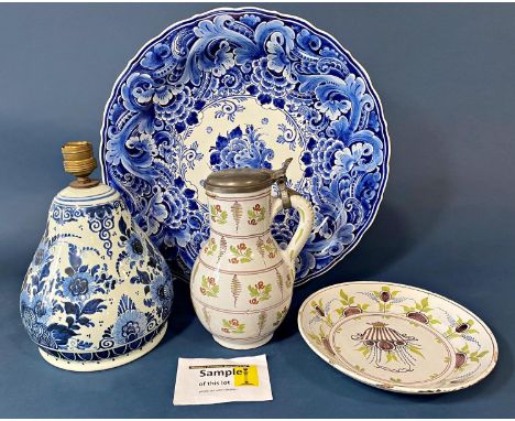 A late 19th century later Delftware comprising dishes, vase and cover, lidded pot, open plates, etc, majority with hand paint