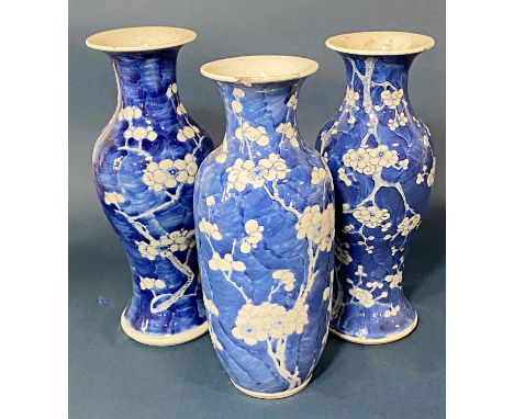 Three Chinese blue and white porcelain prunus vases, each with four-character Kangxi mark to base, tallest 26 cm (3) 