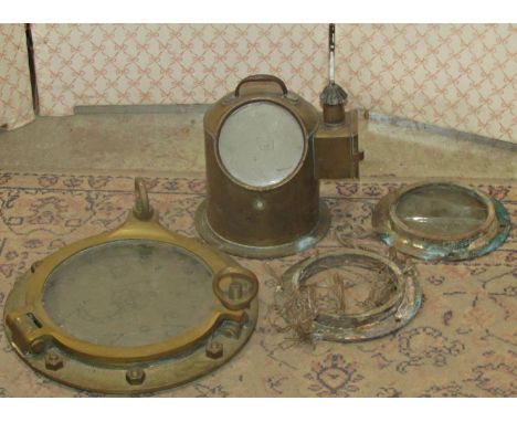 A brass compass cover, a brass sestrel marine barometer by Tratman and Lowther together with three brass port holes 