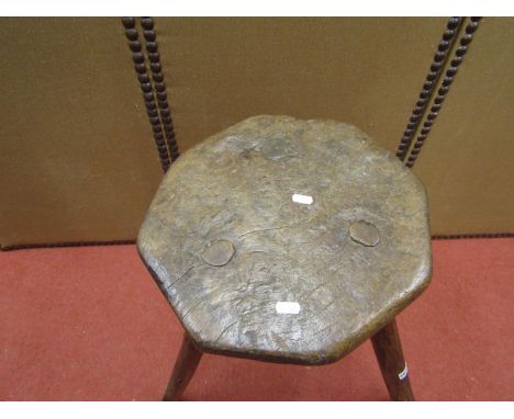 Early rustic stool, the top of octagonal form, raised on three simple stick supports, 60cm H 