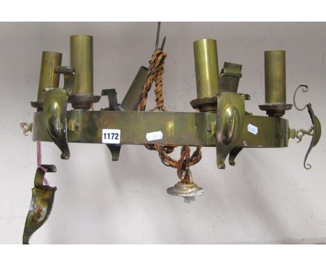 An Edwardian brass hanging ceiling light of simple hooped form supporting six fittings and scrolled shields 60 cm diameter ap