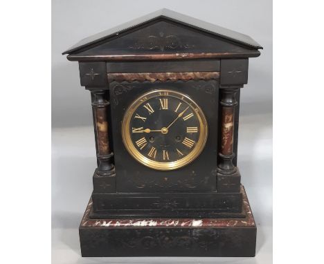 A mid-Victorian period black slate and polished marble mantel clock of architectural form, enclosing a French eight day strik