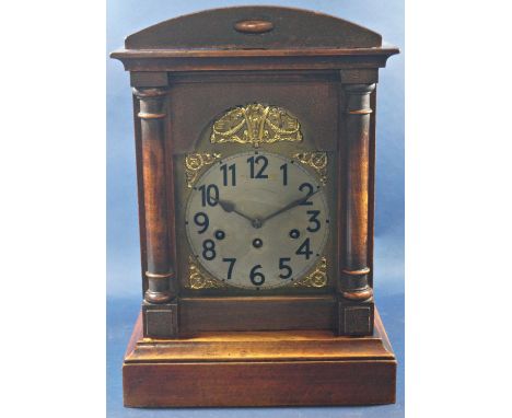 A late 19th century cottage mantle clock with polished softwood case, broken arch dial and applied spandrels, with three trai