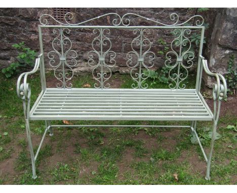 A contemporary light green painted aluminium garden bench with slatted seat, open scrolled arms and back, 117 cm wide 