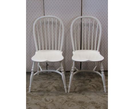 A pair of Georgian style Windsor hoop and stick back armchairs with painted finish, saddle shaped seats, raised on splayed tu