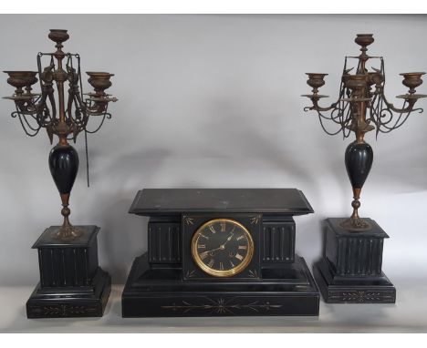 A Victorian clock garniture, the clock in a reeded architectural case with black dial and gold numerals and eight day strikin