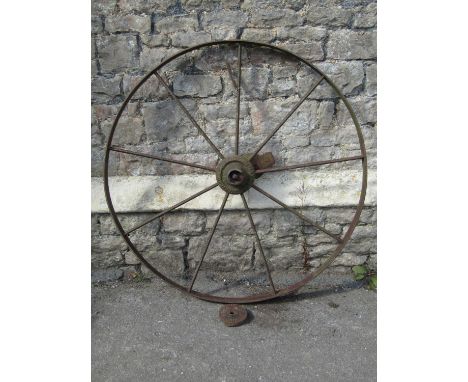 A vintage cast iron nine spoke implement wheel stamped to hub 'Ashby Jeffery Luke Stamford no27' (af) 106 cm diameter 