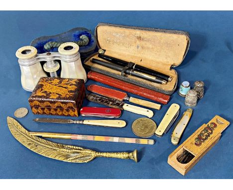 A pair of French mother-of-pearl opera glasses, an Alum Bay sand pen holder, a brass claw and feather pipe stamper, silver th