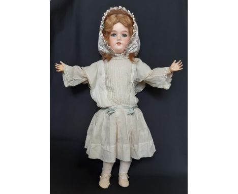 Early 20th century bisque head doll by George Borgfeldt with closing blue eyes, open mouth with teeth and jointed composition