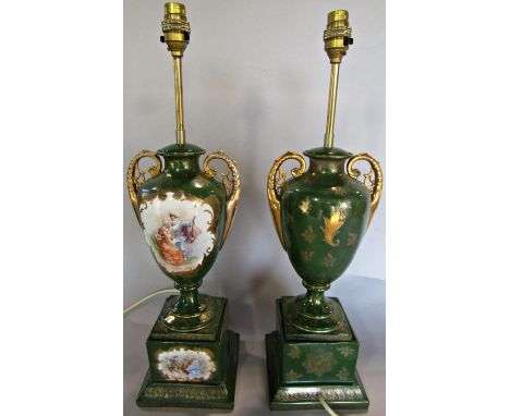 A pair of green china table lamps of vase form with a romantic scenes raised on a plinth base. 57cm high approx 