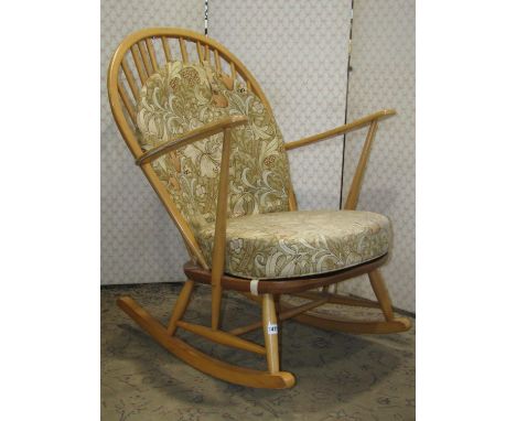 An Ercol rocking chair in a light colourway with stick back principally in beech with elm seat 