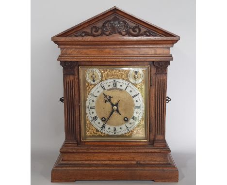 A 19th century German bracket clock, the oak case of architectural form with column support enclosing a square brass dial wit