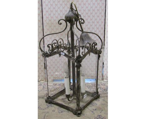 A contemporary reproduction hanging hall lantern, the cast metal frame with scroll and foliate detail and enclosed by four gl