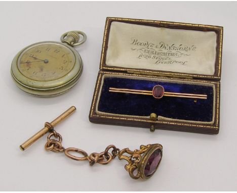 Edwardian 9ct garnet bar brooch, 2g, a Waterbury Watch Co. pocket watch and a gold plated seal fob (3) 