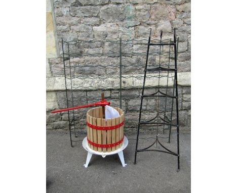 A small fruit press, wooden slatted and steel banded together with a vintage floorstanding five tier graduated saucepan stand