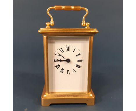 A Simple brass carriage clock enclosing an eight day time piece 