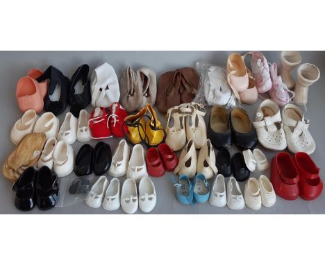A collection of dolls clothes and shoes including hand made sewn and knitted garments, baby socks etc, some vintage (2 boxful