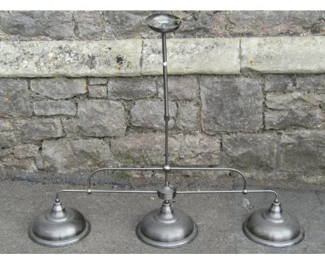A contemporary cast metal hanging ceiling light with three domed shades retailed by Next 