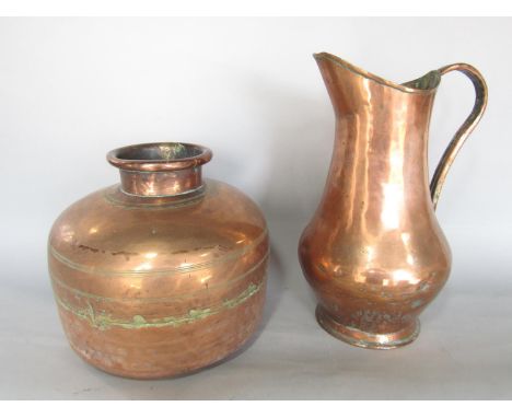 A 19th century flat bottomed copper jar with tapered neck and incised ring design and a 19th century copper pitcher. 