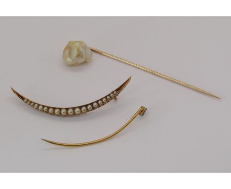 Yellow metal stick pin with large baroque pearl terminal, together with a yellow metal crescent brooch set with graduated pea