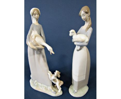 Five Lladro figures of young girls comprising one holding a lamb, another holding a goose with a dog at her feet, both 27cm t